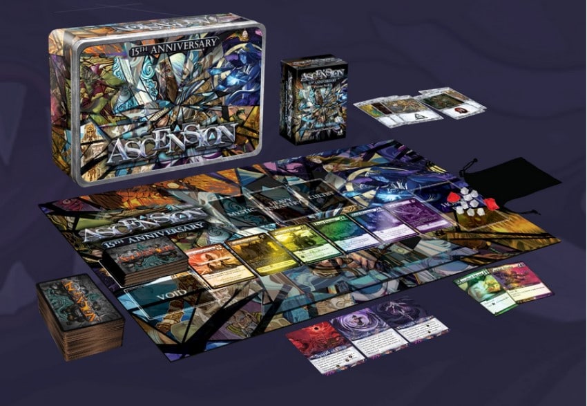 A spread of play mats, cards, sleeves, and play boards on a white background.