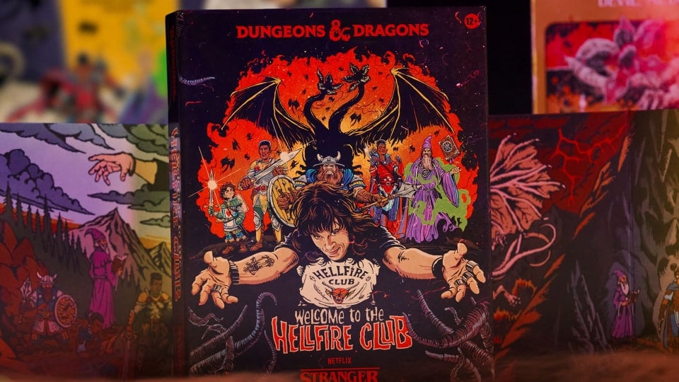 A game box showing a group of adventurers, a two-headed dragon, and a man in a black t-shirt with his arms outstretched.