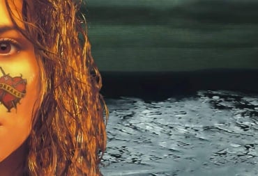 Artwork for Forsaken 64 (now on Nintendo Switch Online), which shows a woman with a heart tattoo on her cheek crying and the game's logo