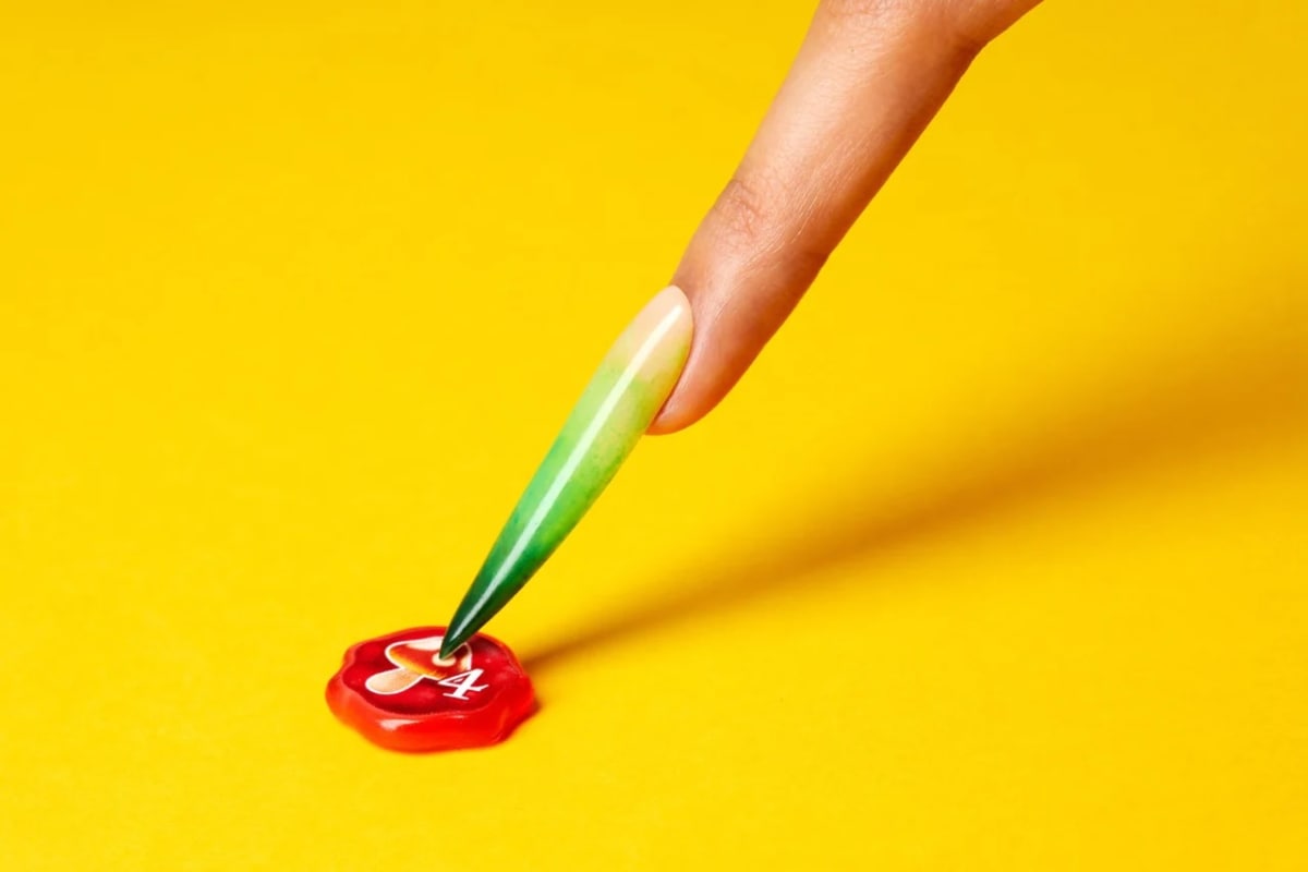 An image from Quacks featuring nail art pointing to a miniature