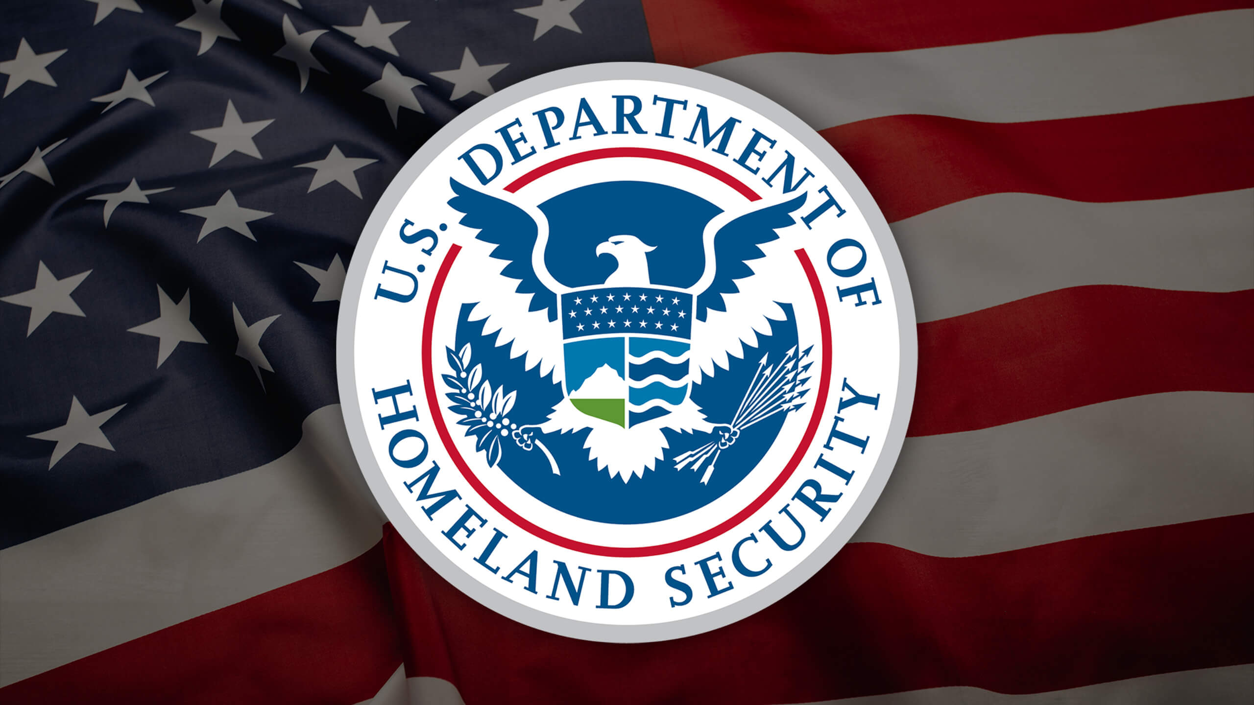 The logo for the US Department of Homeland Security against the backdrop of an American flag