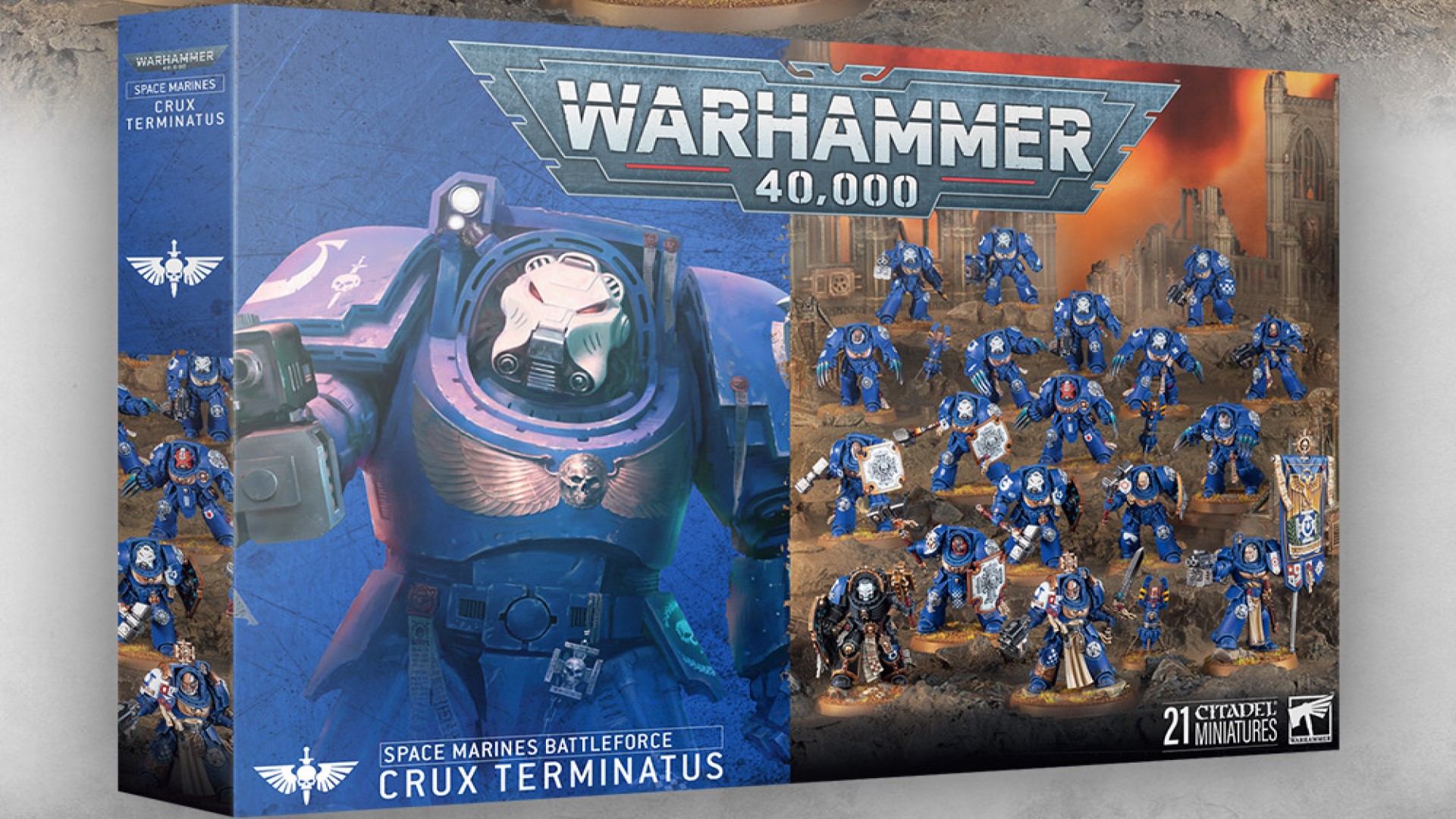 A game box featuring multiple blue-armored Space Marines holding shields and battle standards.
