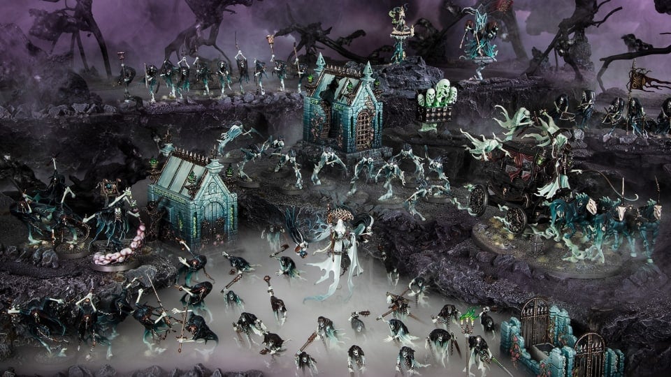 A table depicting an abandoned mausoleum with miniatures of skeletons and ghosts in front.