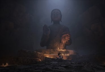 Protagonist Bai Wuchang sitting in front of a large statue.